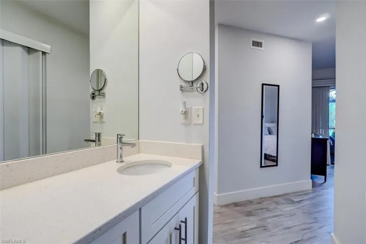 Bathroom featuring vanity and wood-type flooring