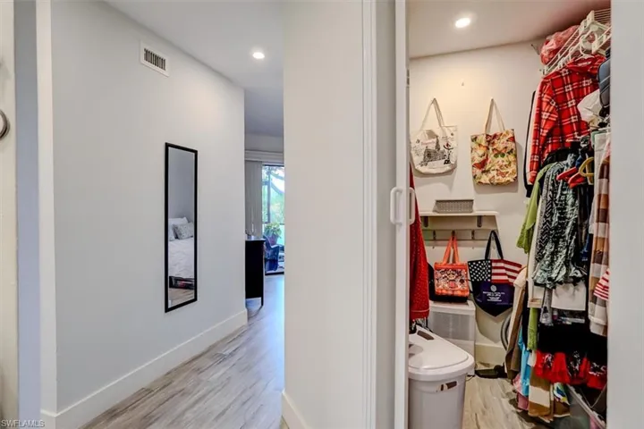 Primary Bedroom Closet and Hall featuring light hardwood / wood-style flooring