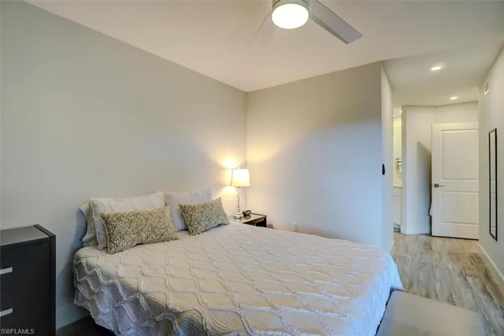 Bedroom with ceiling fan and wood-type flooring