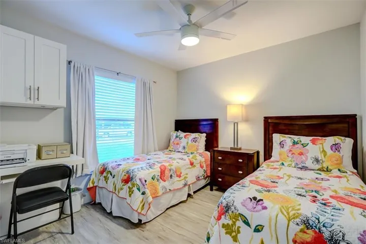 Bedroom with ceiling fan and light wood-type flooring
