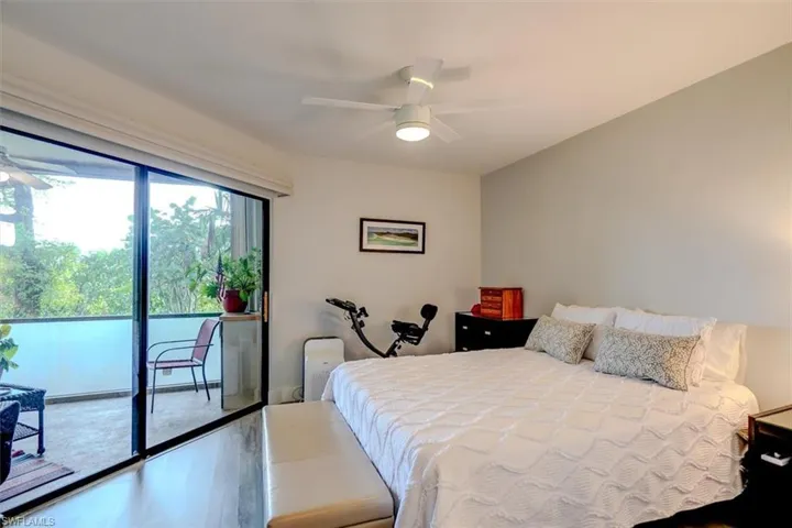 Bedroom featuring hardwood / wood-style floors, access to outside, and ceiling fan