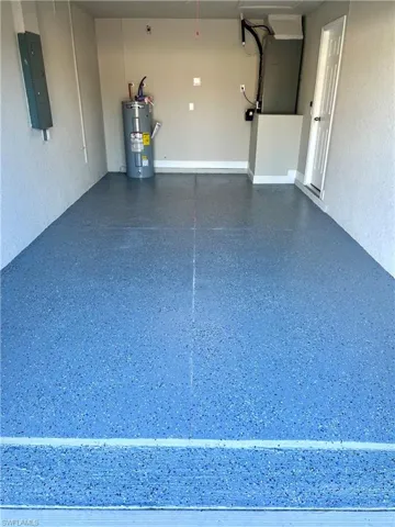 Garage with water heater and electric panel