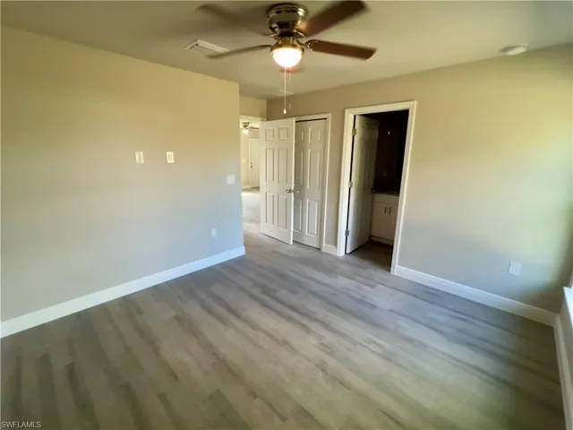 Unfurnished room featuring ceiling fan and wood-type flooring