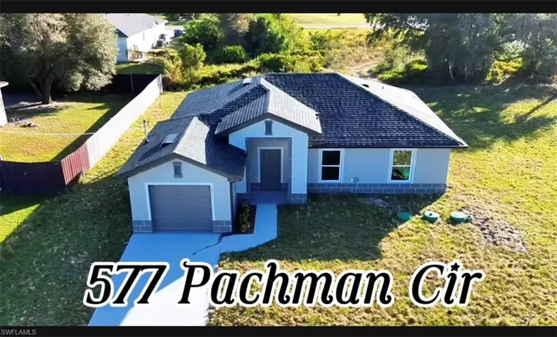 View of front of house featuring a front lawn and a garage