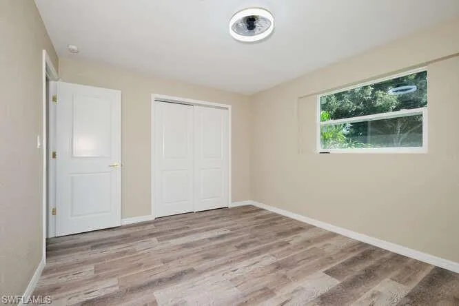 Unfurnished bedroom featuring a closet and light hardwood / wood-style flooring