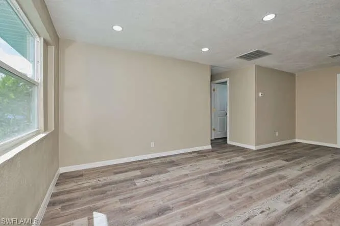 Empty room featuring hardwood / wood-style floors