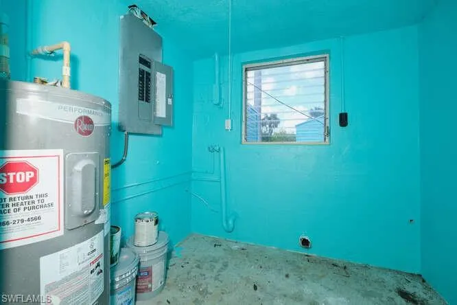 Utility room with electric water heater and electric panel