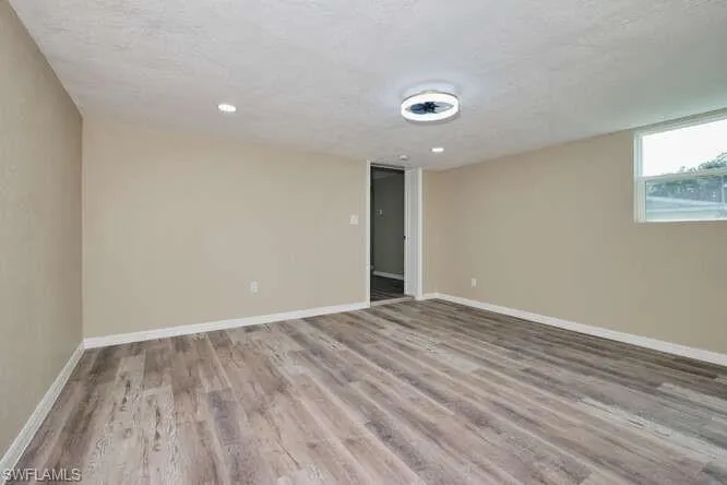 Spare room with hardwood / wood-style flooring and a textured ceiling