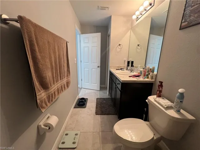 Bathroom featuring vanity and light tile patterned floors