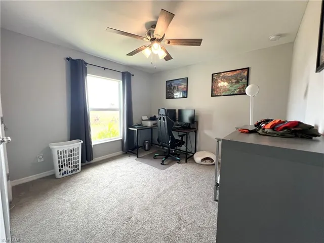 Office featuring light carpet and a ceiling fan