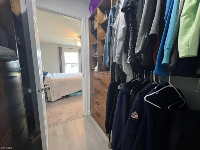 Spacious closet with light wood finished floors