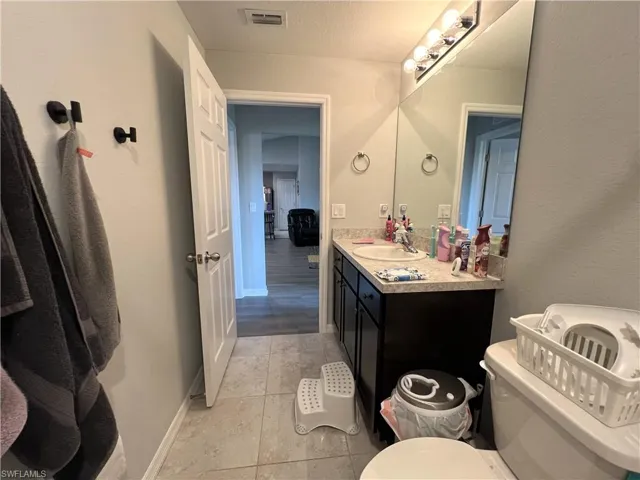Bathroom featuring vanity and light tile patterned flooring