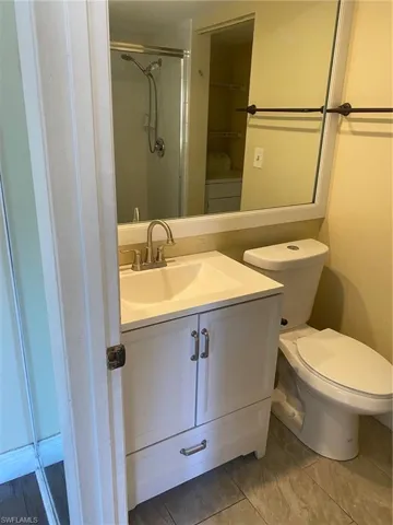 Full 1st floor bath with vanity, washer / dryer, and a shower stall