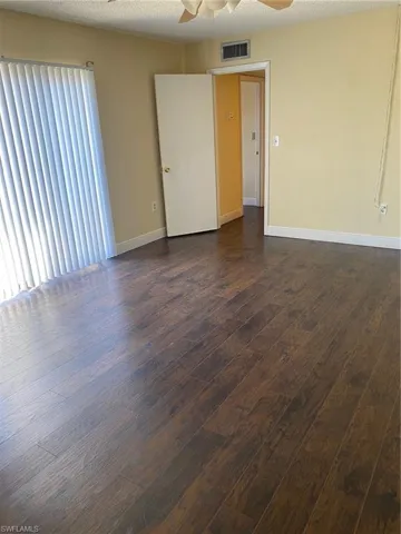 Bedroom 1 featuring a ceiling fan and laminate floors.