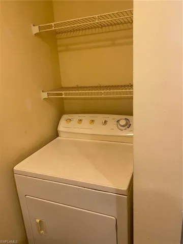 Laundry area featuring dryer in 1st floor bathroom.