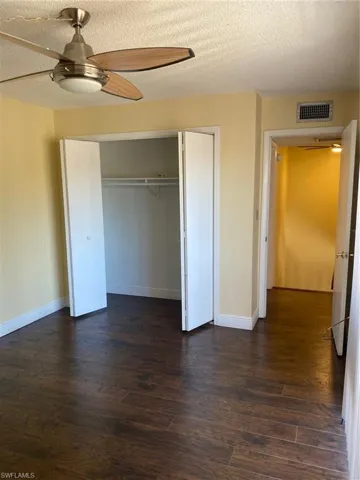 Bedroom 2 featuring  laminate floors, a closet and a ceiling fan.