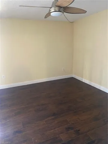 Bedroom 2 featuring ceiling fan and laminate flooring.