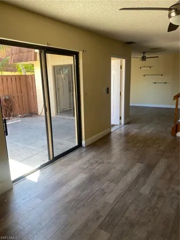 Family room with vinyl  floors, and a ceiling fan.
