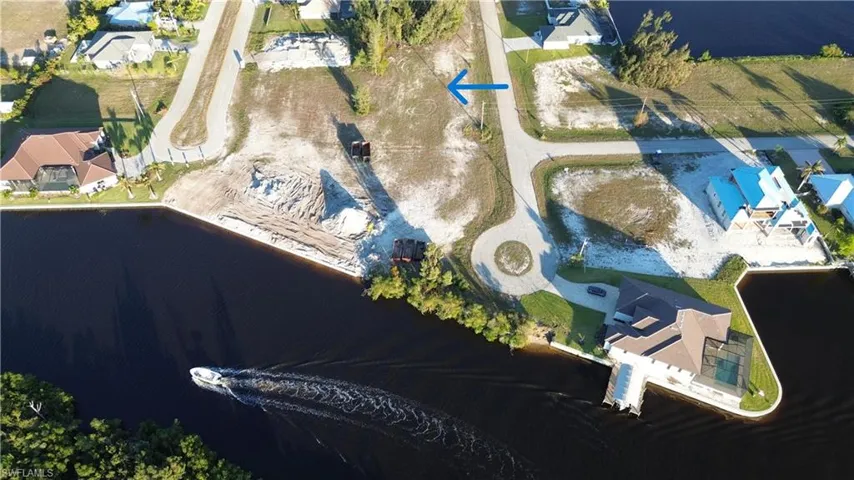 Birds eye view of property with a water view