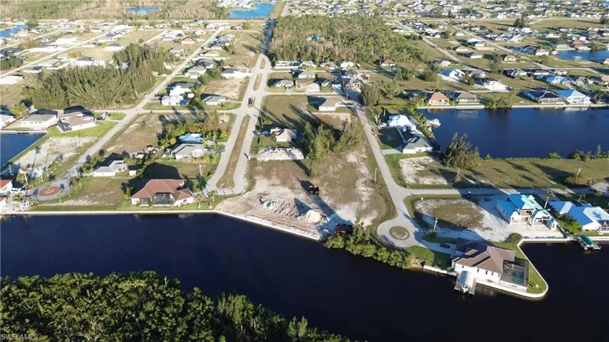 Birds eye view of property with a water view