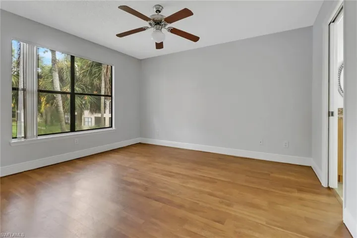 Unfurnished room featuring a textured ceiling, light hardwood / wood-style flooring, and ceiling fan