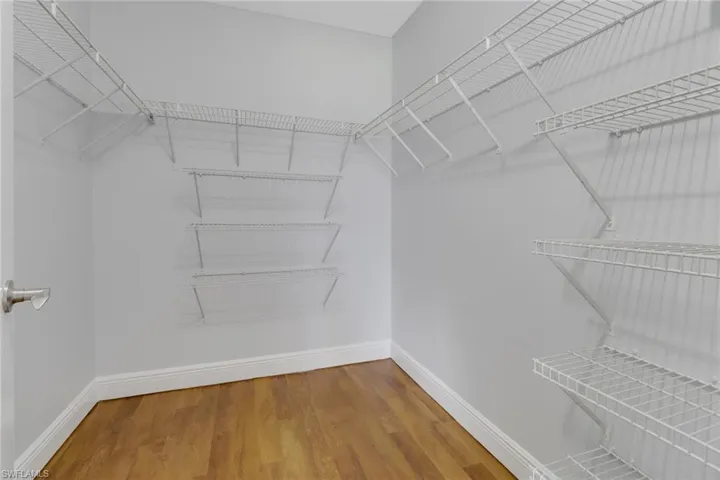 Walk in closet featuring hardwood / wood-style flooring