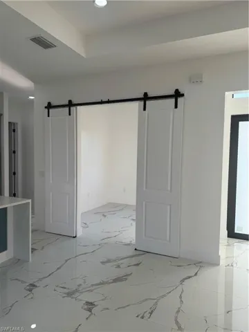 Tiled empty room with a barn door