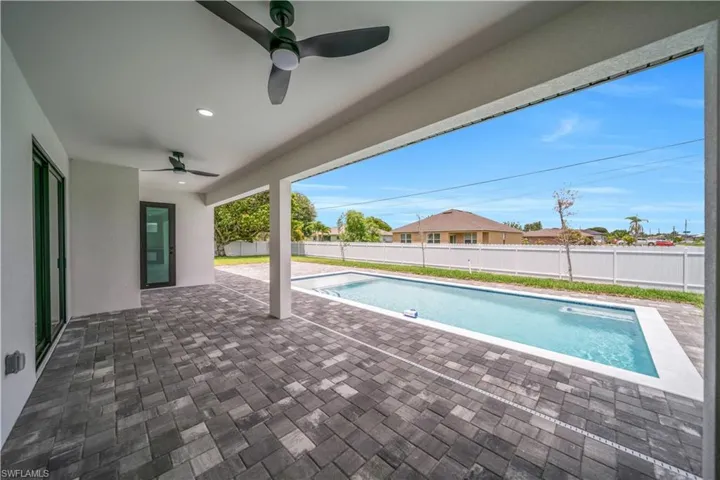 View of swimming pool with a fenced backyard, a patio area, and a ceiling fan