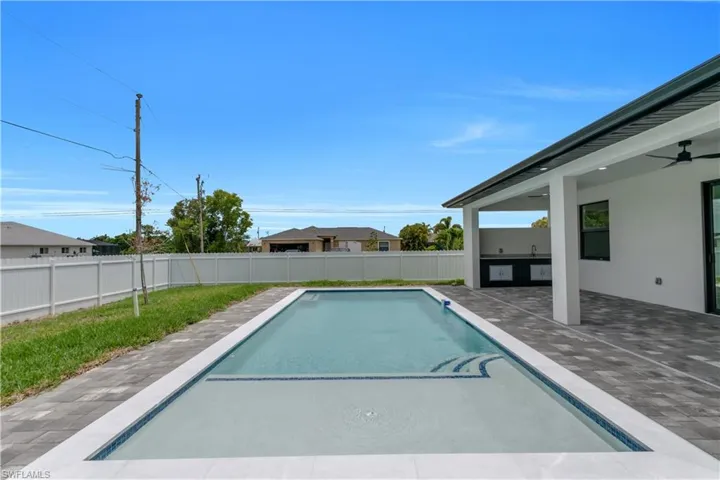 View of pool featuring a patio area, a fenced backyard, and ceiling fan