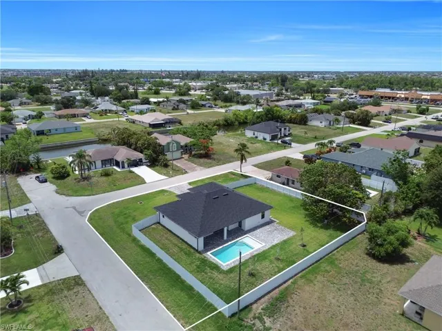 Aerial perspective of suburban area featuring a pool