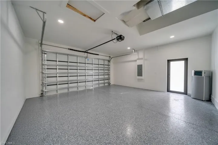 Garage with recessed lighting and electric panel