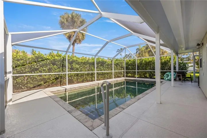 Outdoor pool featuring a patio area, a sunroom, and a lanai