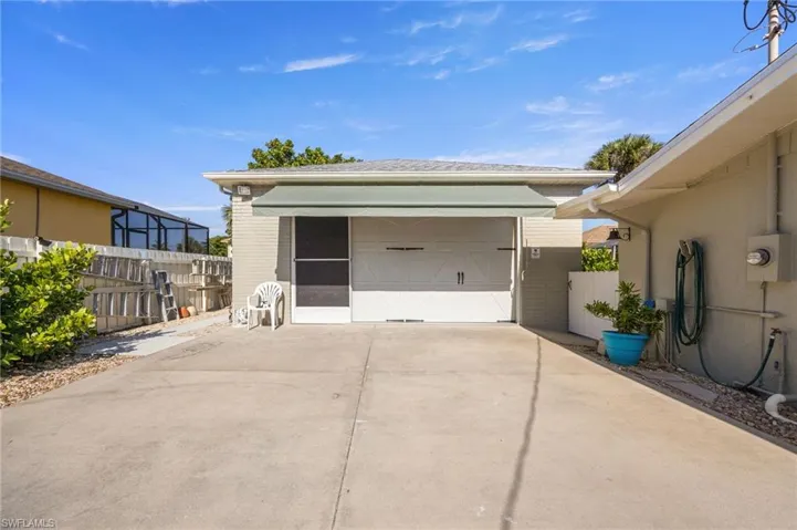 Detached garage featuring concrete driveway