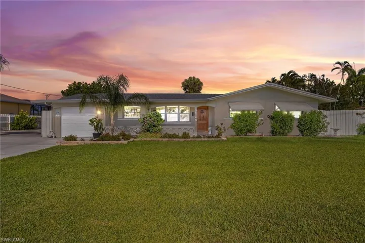 Ranch-style house featuring a garage and concrete driveway