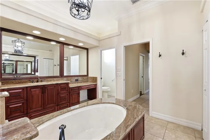 Walk in shower with extra niches on each side and freestanding tub.
