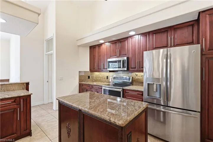 Gourmet kitchen with grainte countertops, pot filler and stainless steel appliances