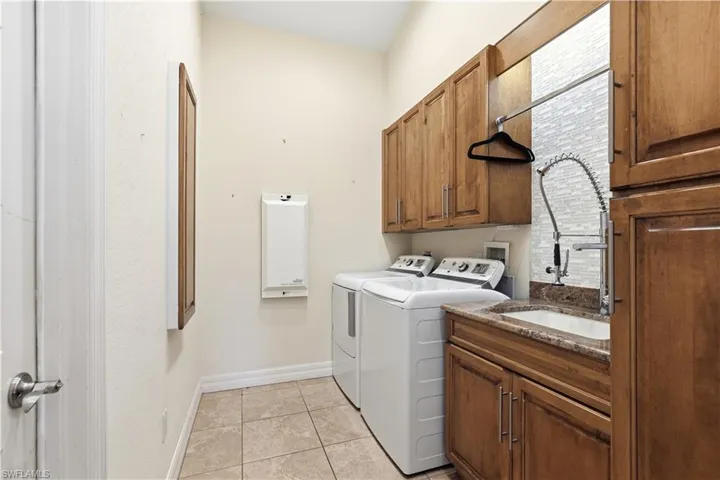 laundry room with sink, extra cabinets and pull out drawers.