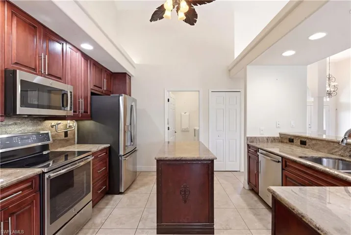 Gourmet kitchen with grainte countertops, pot filler and stainless steel appliances