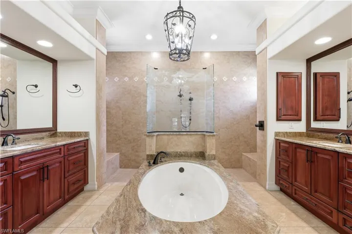 Walk in shower with extra niches on each side and freestanding tub.