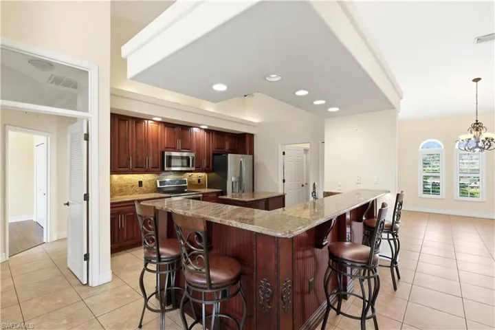 Gourmet kitchen with grainte countertops, pot filler and stainless steel appliances