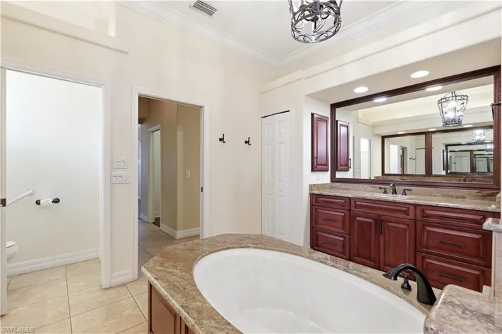 Walk in shower with extra niches on each side and freestanding tub.