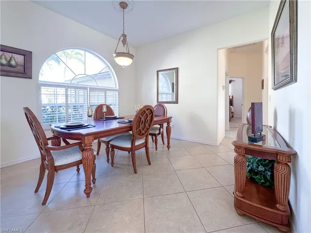 Dining room with light tile patterned floors and baseboards