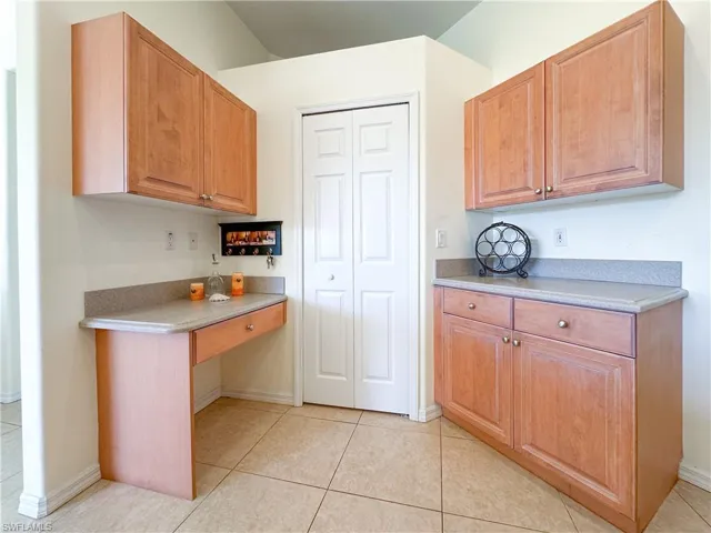 Kitchen with light tile patterned floors and baseboards