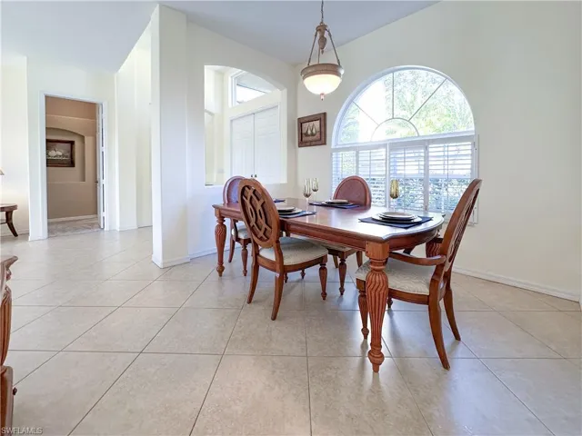 Dining space with light tile patterned floors and baseboards