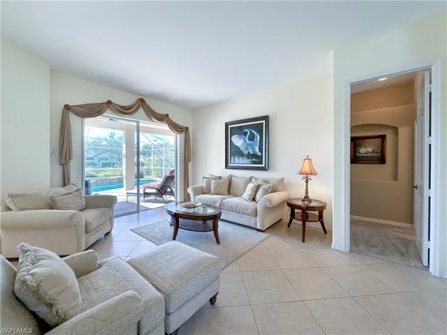 Living room featuring light tile patterned floors and baseboards