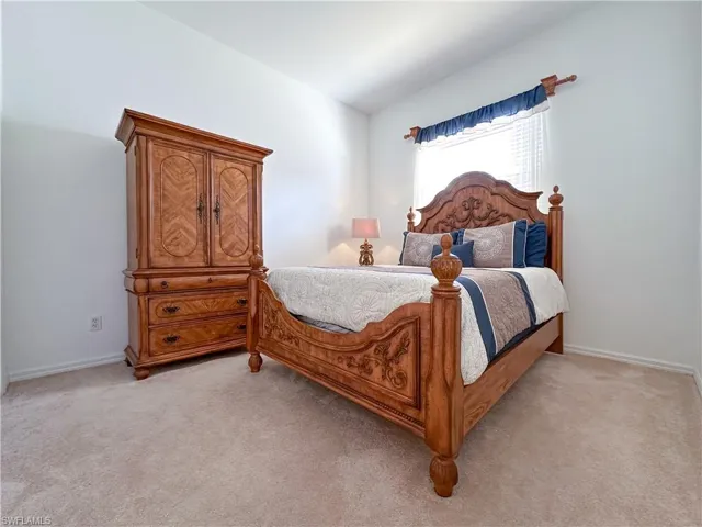 Bedroom with light colored carpet