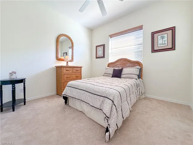 Bedroom featuring light carpet and a ceiling fan
