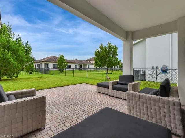 Fenced backyard with outdoor furniture, a patio area, and a residential view