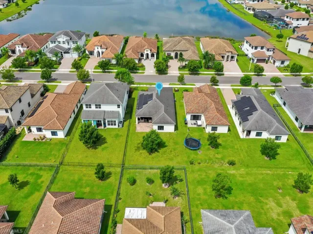 Aerial view of residential area featuring a nearby body of water