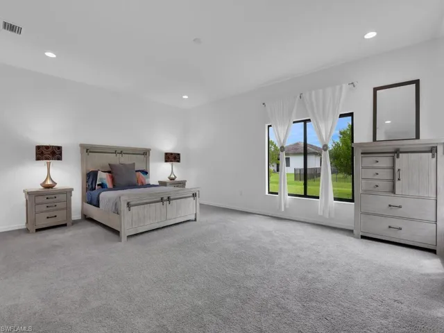 Bedroom featuring light carpet and recessed lighting